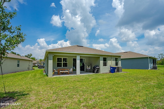 rear view of house featuring a yard and a patio