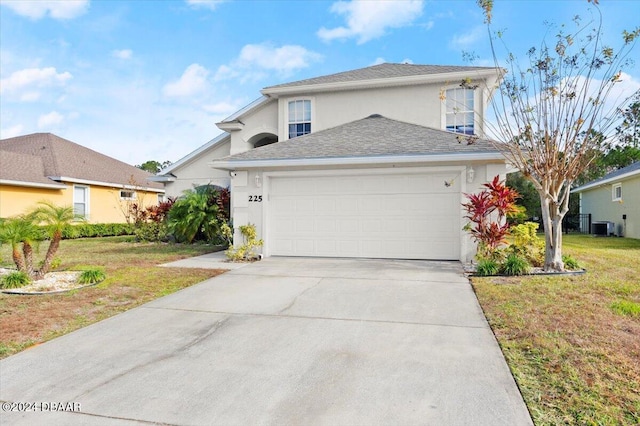 view of front of property featuring central AC unit, a garage, and a front lawn