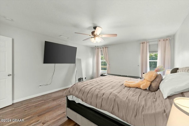 bedroom with hardwood / wood-style floors and ceiling fan