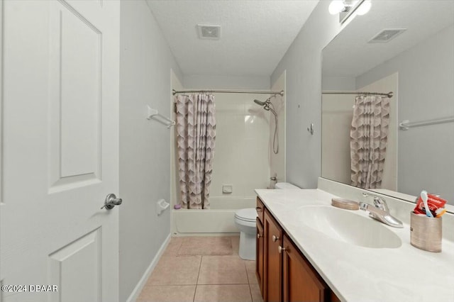 full bathroom with shower / tub combo, tile patterned floors, vanity, a textured ceiling, and toilet