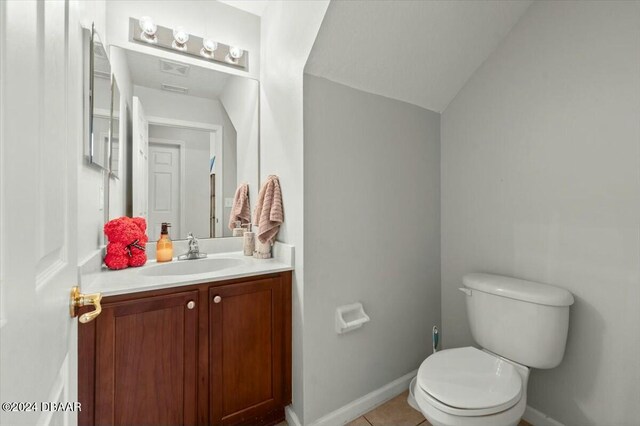 bathroom featuring tile patterned floors, vanity, and toilet