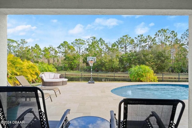 view of pool with an outdoor living space and a patio area