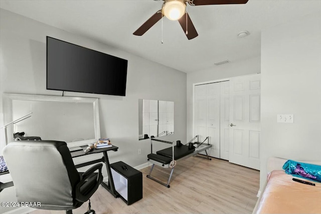 home office featuring ceiling fan and light hardwood / wood-style floors