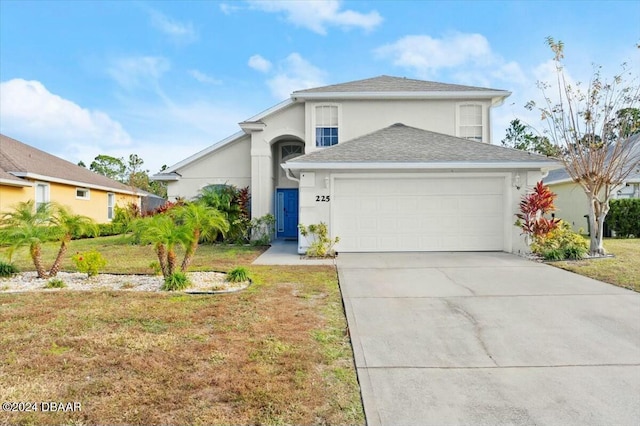 front of property with a garage and a front lawn