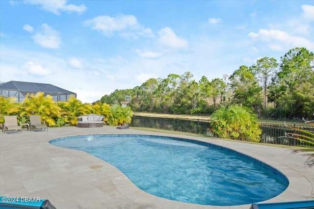 view of pool with a water view and a patio