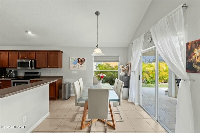 kitchen featuring light tile patterned floors, pendant lighting, and appliances with stainless steel finishes