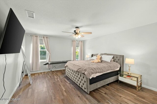 bedroom with hardwood / wood-style floors and ceiling fan