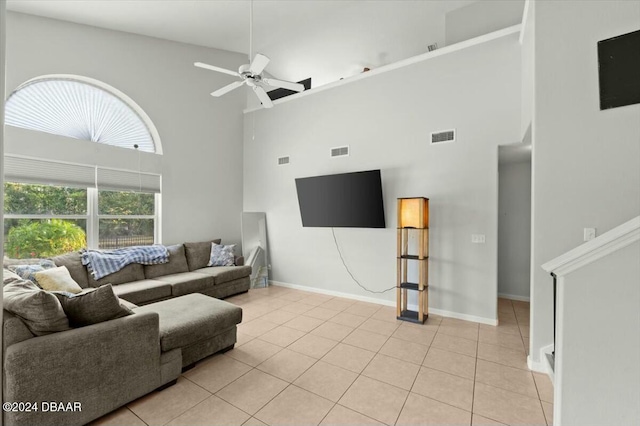 tiled living room with a towering ceiling and ceiling fan