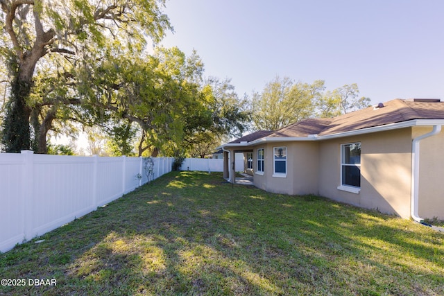 view of yard with a fenced backyard