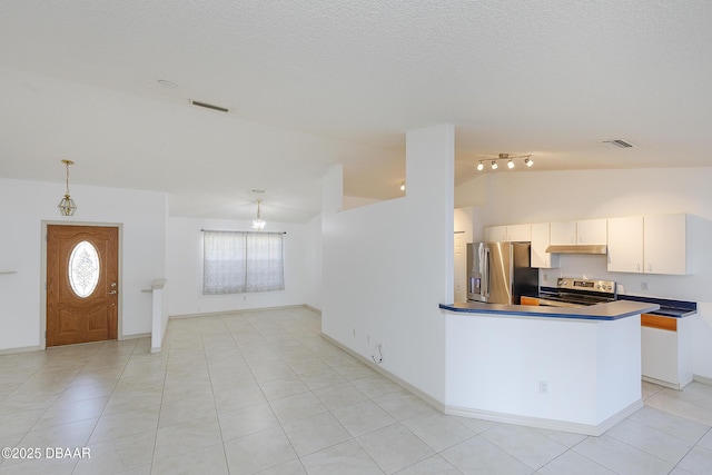 kitchen with visible vents, under cabinet range hood, dark countertops, appliances with stainless steel finishes, and lofted ceiling