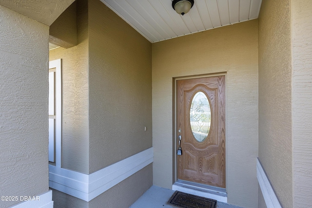 entrance to property with stucco siding