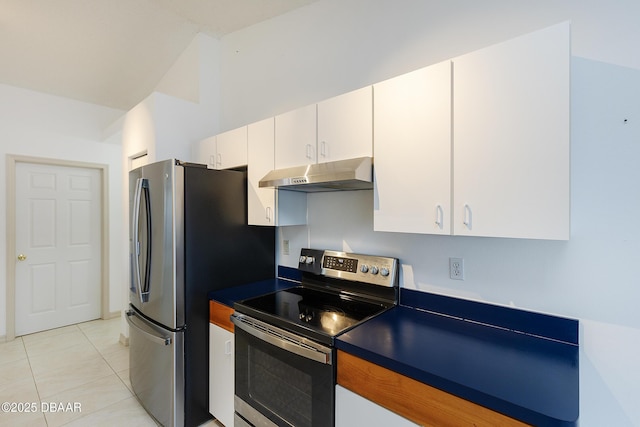 kitchen featuring under cabinet range hood, dark countertops, appliances with stainless steel finishes, light tile patterned flooring, and white cabinets