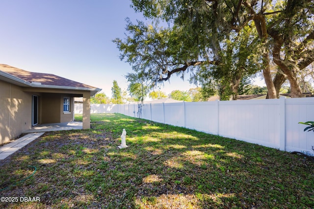 view of yard with a fenced backyard and a patio area