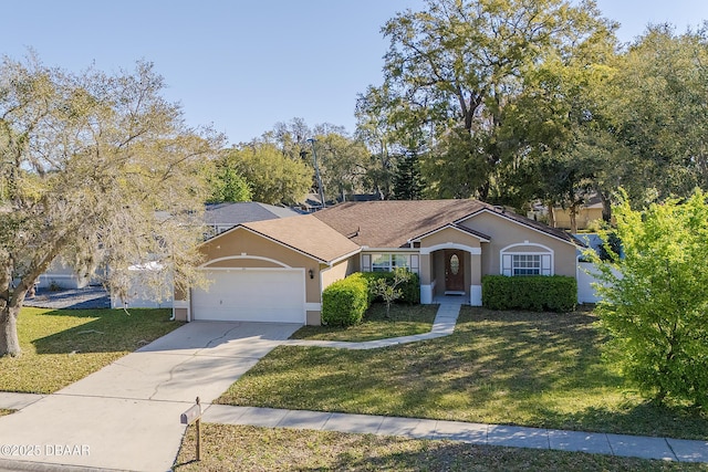 ranch-style house featuring a garage, stucco siding, driveway, and a front lawn