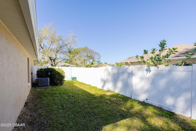 view of yard featuring central AC unit and a fenced backyard