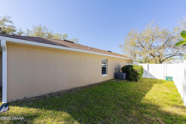 exterior space featuring a gate, fence, and cooling unit