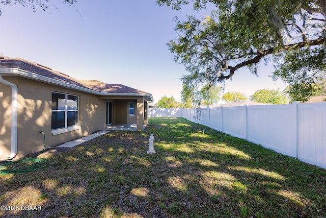 view of yard with a fenced backyard