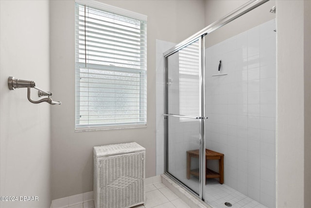 bathroom featuring tile patterned floors, a healthy amount of sunlight, and an enclosed shower