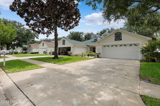 view of front facade with a garage and a front lawn