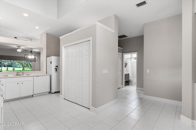 kitchen with sink, light tile patterned floors, decorative light fixtures, white appliances, and white cabinets