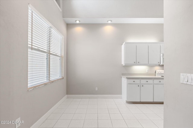 kitchen with white cabinetry and light tile patterned floors