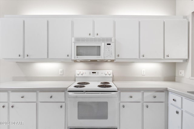 kitchen featuring white appliances and white cabinetry