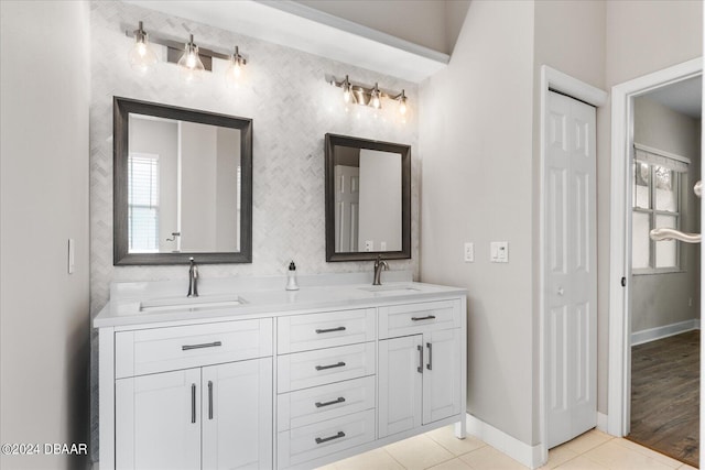 bathroom with hardwood / wood-style flooring, vanity, and a healthy amount of sunlight