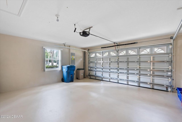 garage featuring electric panel and a garage door opener