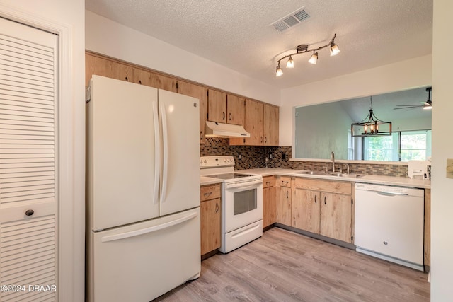 kitchen with white appliances, hanging light fixtures, sink, a textured ceiling, and ceiling fan with notable chandelier