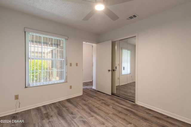 empty room featuring ceiling fan, a textured ceiling, and hardwood / wood-style flooring