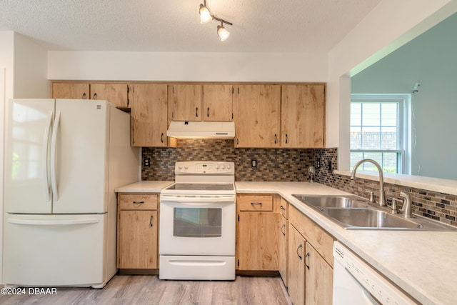 kitchen with white appliances, tasteful backsplash, a textured ceiling, and sink