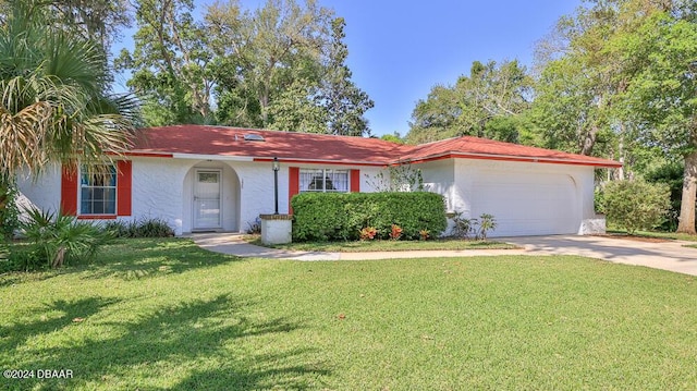 ranch-style house with a garage and a front yard