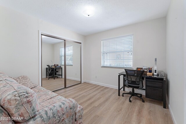 3167 S Peninsula Dr, Daytona Beach, FL 32118 - office space featuring light wood finished floors, a textured ceiling, and baseboards