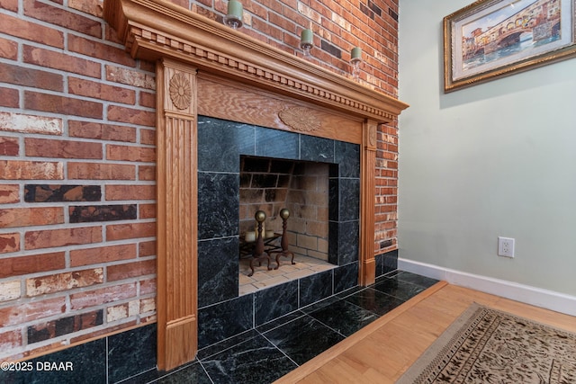 3167 S Peninsula Dr, Daytona Beach, FL 32118 - interior details featuring a fireplace, baseboards, and wood finished floors