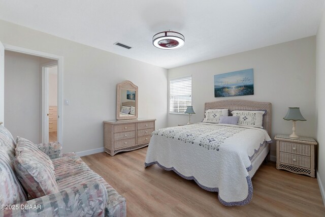 3167 S Peninsula Dr, Daytona Beach, FL 32118 - bedroom featuring visible vents, baseboards, and light wood-style floors