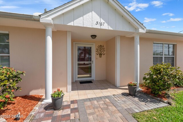 3167 S Peninsula Dr, Daytona Beach, FL 32118 - doorway to property featuring stucco siding