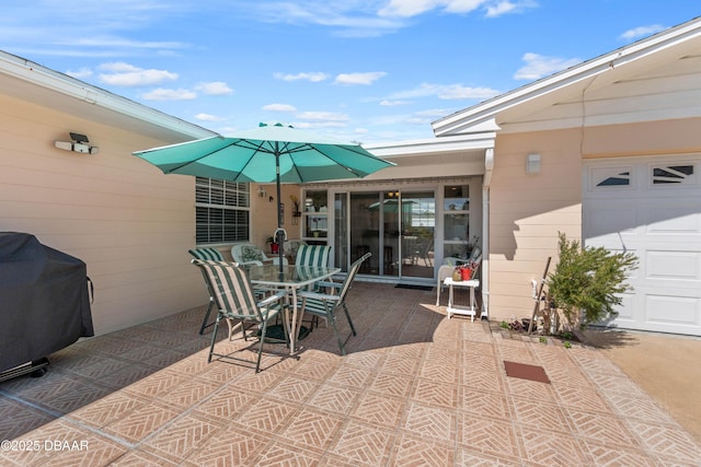 3167 S Peninsula Dr, Daytona Beach, FL 32118 - view of patio / terrace featuring outdoor dining space, an attached garage, and grilling area
