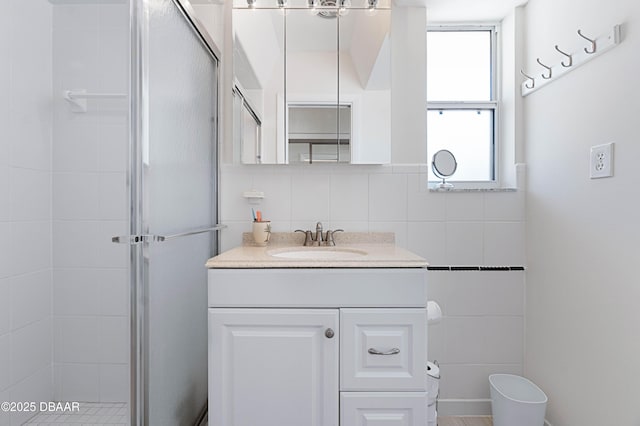 3167 S Peninsula Dr, Daytona Beach, FL 32118 - full bathroom with vanity, a shower stall, and tile walls