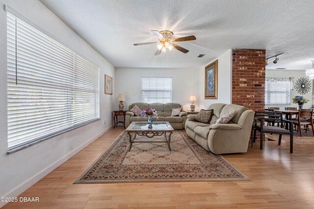 3167 S Peninsula Dr, Daytona Beach, FL 32118 - living area with light wood-type flooring, a textured ceiling, and ceiling fan