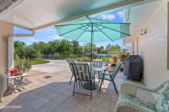 3167 S Peninsula Dr, Daytona Beach, FL 32118 - view of patio / terrace featuring a grill, outdoor dining area, and fence