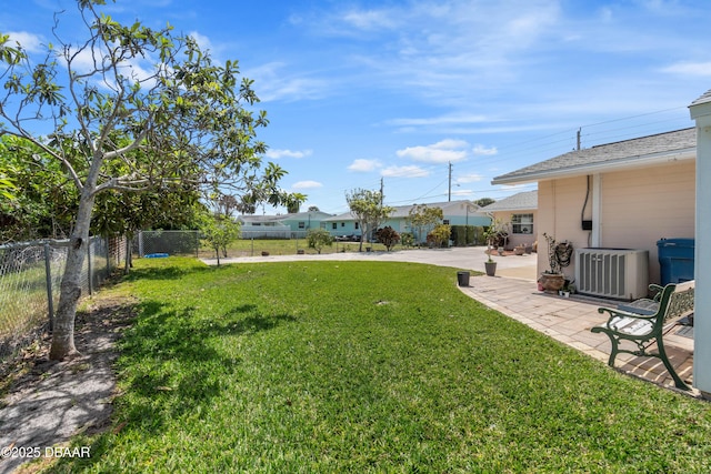 3167 S Peninsula Dr, Daytona Beach, FL 32118 - view of yard featuring a patio, central AC, driveway, and fence