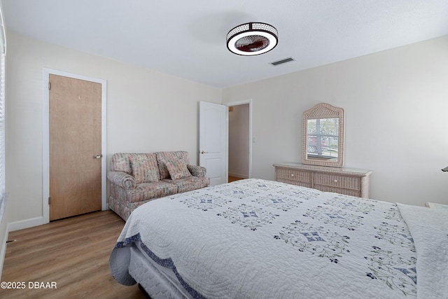 3167 S Peninsula Dr, Daytona Beach, FL 32118 - bedroom featuring visible vents, baseboards, and light wood-style flooring