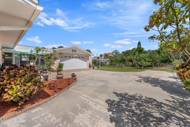 3167 S Peninsula Dr, Daytona Beach, FL 32118 - exterior space featuring concrete driveway, fence, and a garage