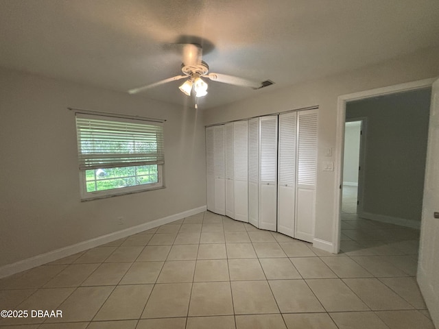 917 Royal Oak Ct, Holly Hill, FL 32117 - unfurnished bedroom with light tile patterned floors, a closet, and ceiling fan