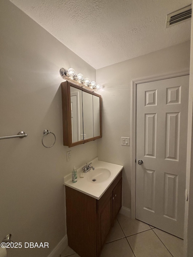 917 Royal Oak Ct, Holly Hill, FL 32117 - bathroom with vanity, a textured ceiling, and tile patterned flooring