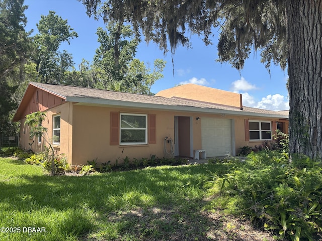 917 Royal Oak Ct, Holly Hill, FL 32117 - ranch-style home featuring an attached garage, board and batten siding, a front yard, and stucco siding