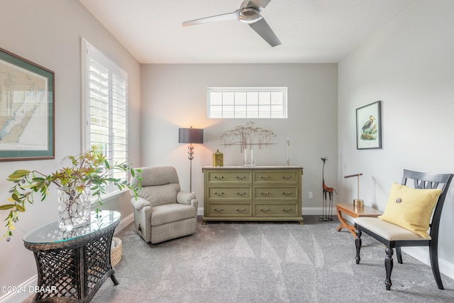 sitting room with light colored carpet, ceiling fan, and plenty of natural light