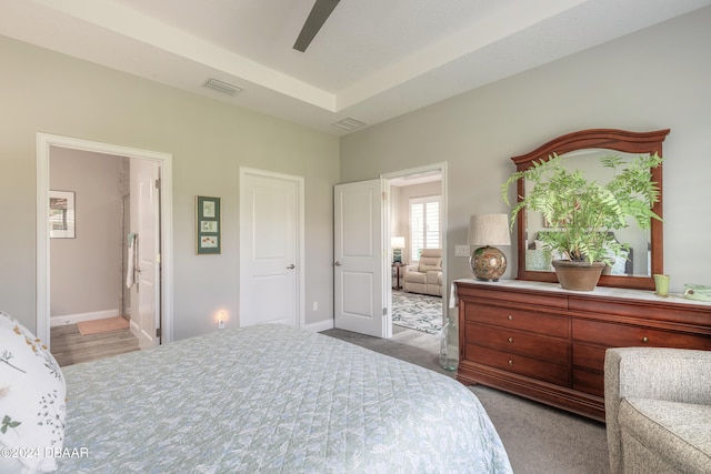 carpeted bedroom with ceiling fan and ensuite bathroom