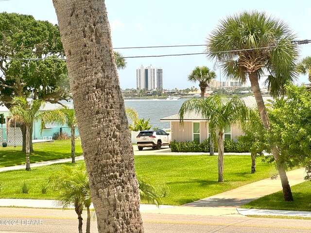 exterior space featuring a yard and a water view