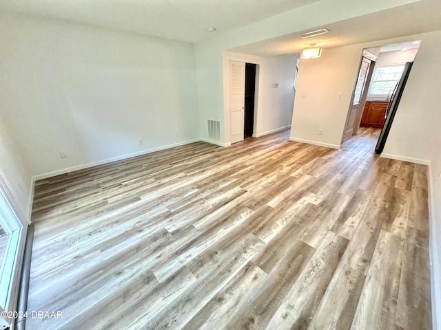 unfurnished room with light wood-type flooring